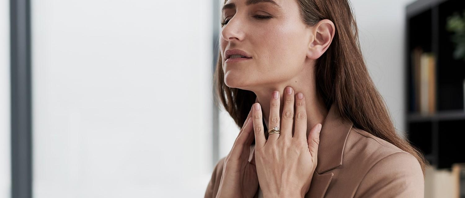 Woman touching neck